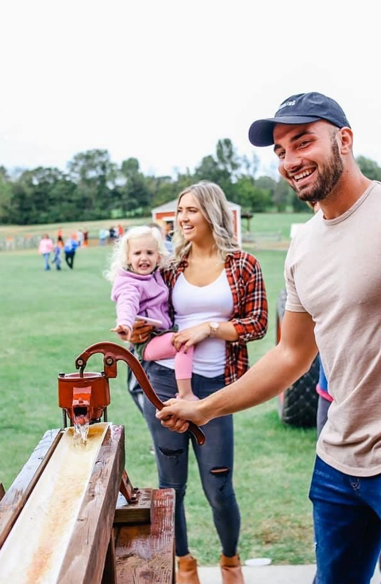 A family pressing fresh apple cider together
